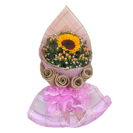 Vibrant sunflower centerpiece: A single sunflower complemented by Hypericum berries, Aster fillers, wrapped in Korean-style wrap with rustic burlap and net accents. Perfect for delivery to Mall of Asia Arena and Manila Baywalk.