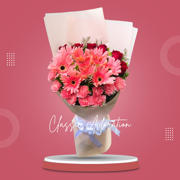 Stunning floral arrangement with light pink gerberas, carnations, red roses, and misty blue fillers in a Korean wrap. Enhanced with a satin ribbon for an elegant touch. Perfect for weddings and special occasions. Flower delivery in Cavite City, Cavite.