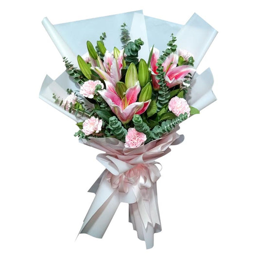 Stunning bouquet featuring three beautiful stargazer lilies and a dozen vibrant carnations, complemented by fresh eucalyptus leaves. Expertly wrapped in a Korean-style wrap and adorned with a satin ribbon. Celebrate any occasion with this enchanting bouquet. Flower delivery in Cainta, Rizal.