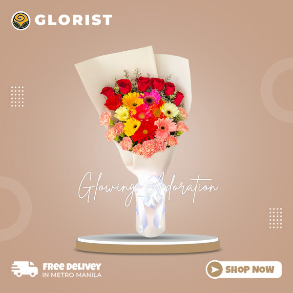 Stunning floral arrangement featuring 10 multi-colored gerberas, 10 carnations, 6 red roses, and misty blue fillers in white Korean wrap with white satin ribbon - elegant flower arrangement for weddings and special occasions - flower delivery to SM City San Pablo and SM City Taytay