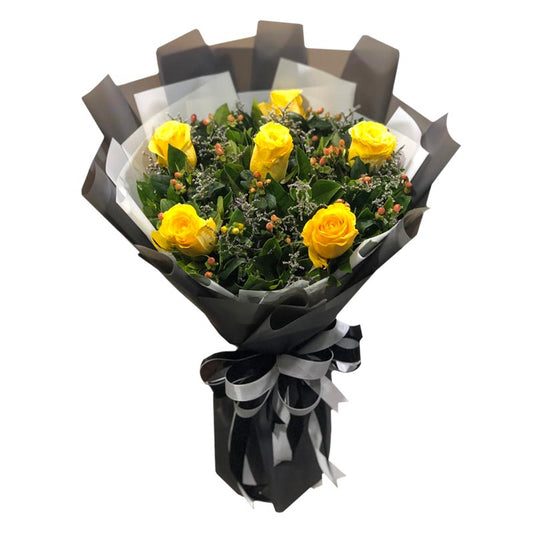 Yellow Ecuadorian roses with hypericum berries and misty blue fillers in Korean-style packaging with satin ribbon - vibrant flower arrangement for special occasions - flower delivery in San Miguel, Bulacan