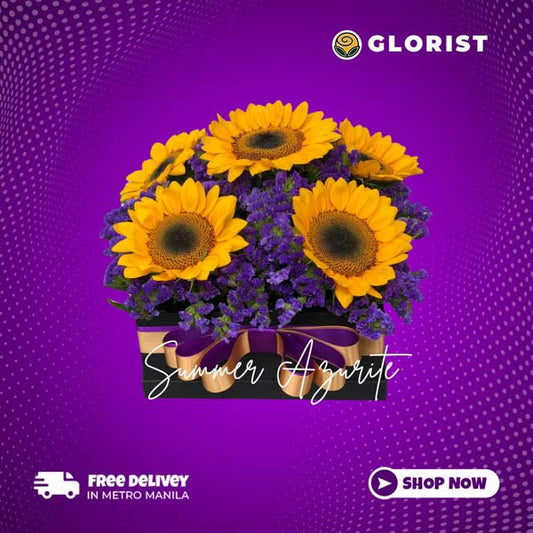 A charming box arrangement featuring 6 vibrant Sunflowers accompanied by delicate Misty Blue Fillers. The flowers are thoughtfully arranged in a stylish box, adorned with a luxurious Satin Ribbon, creating an elegant and captivating display.